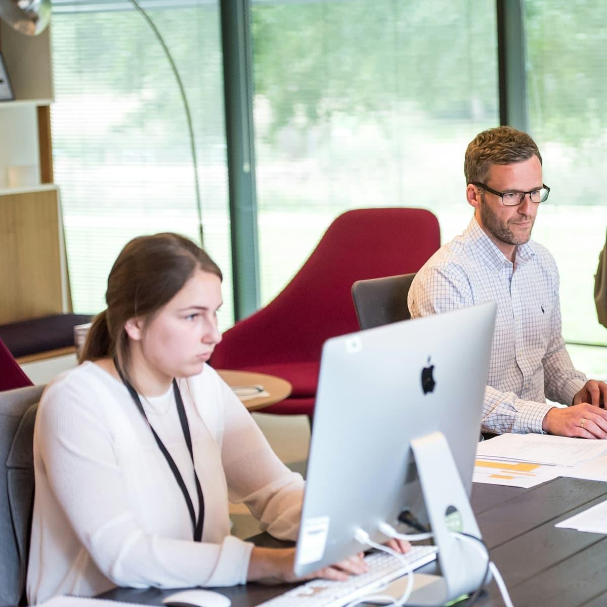 A team working at their screens in a modern office